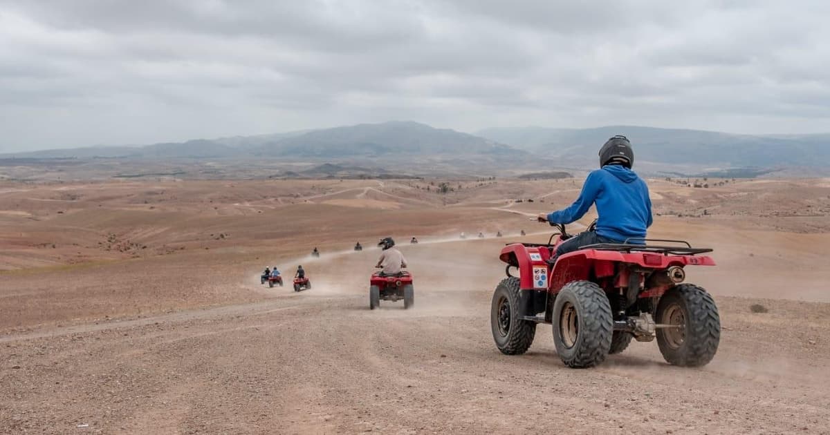 Convoy of red quad bikes crossing the desert